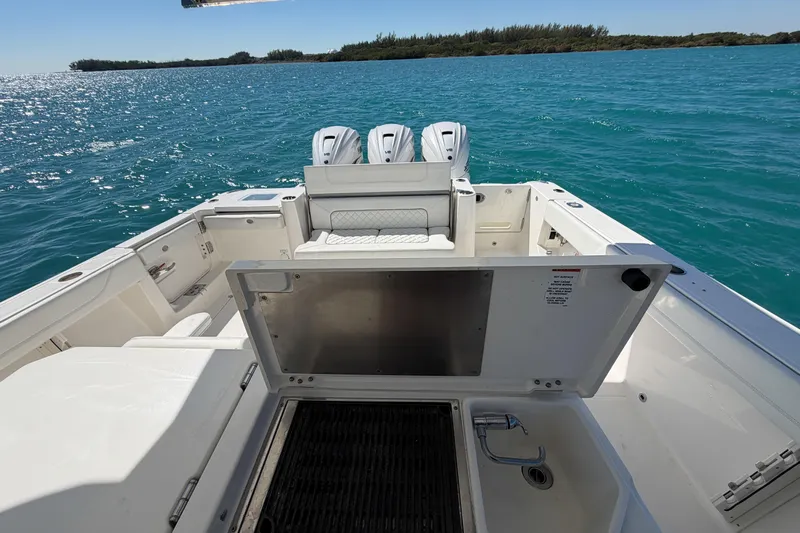  Yacht Photos Pics 2021 Pursuit S 378 Sport boat with open deck and triple engines on blue water.