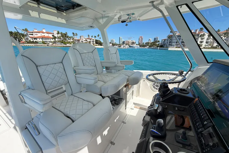  Yacht Photos Pics Interior of 2021 Pursuit S 378 Sport boat with luxurious seating and modern controls.