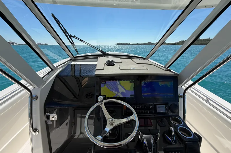  Yacht Photos Pics Interior view of 2021 Pursuit S 378 Sport boat cockpit with navigation screens.