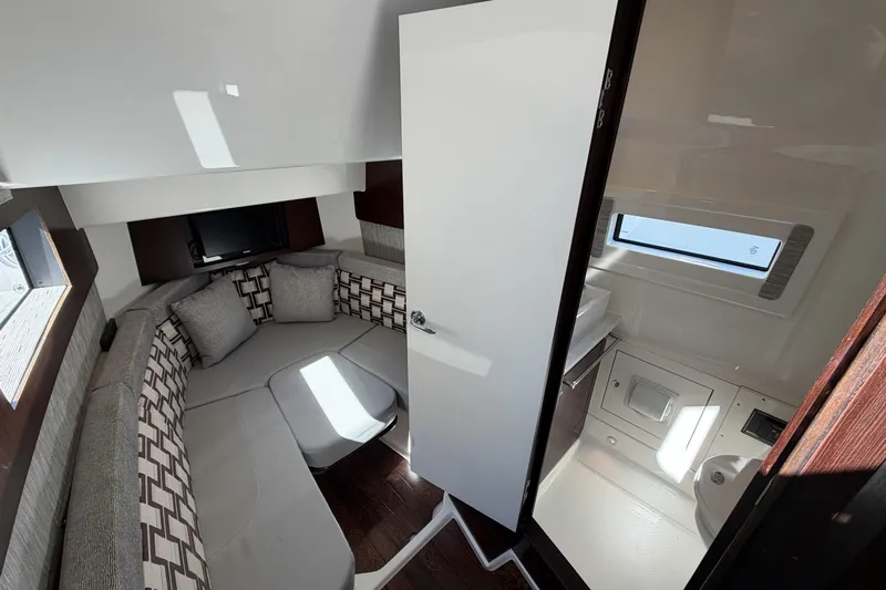  Yacht Photos Pics Luxurious interior of 2021 Pursuit S 378 Sport boat with seating and bathroom.