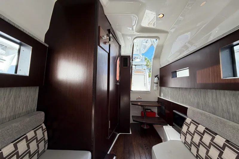  Yacht Photos Pics Interior of 2021 Pursuit S 378 Sport boat with modern seating and wood accents.