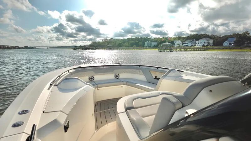  Yacht Photos Pics 2023 Scout 377 LXF boat on a scenic river with luxury seating and waterfront homes.