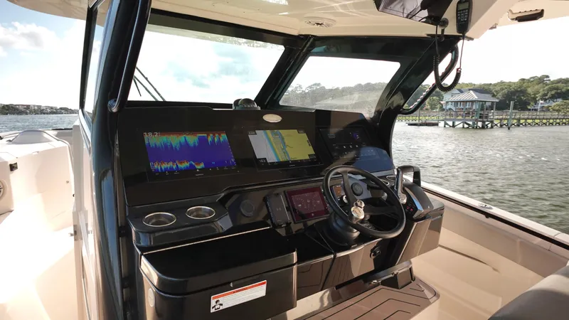  Yacht Photos Pics 2023 Scout 377 LXF boat helm with advanced navigation displays and controls.