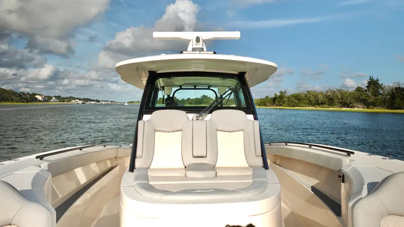 Yacht Photos Pics 2023 Scout 377 LXF boat on calm water with scenic background.