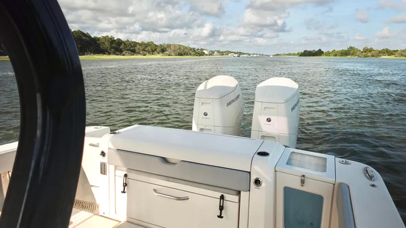  Yacht Photos Pics 2023 Scout 377 LXF boat with dual Mercury engines on a scenic waterway.