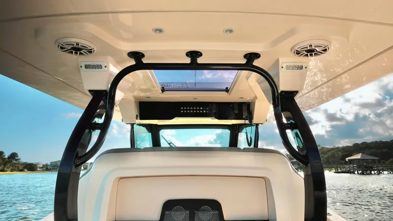  Yacht Photos Pics 2023 Scout 377 LXF boat interior with speakers and open water view.