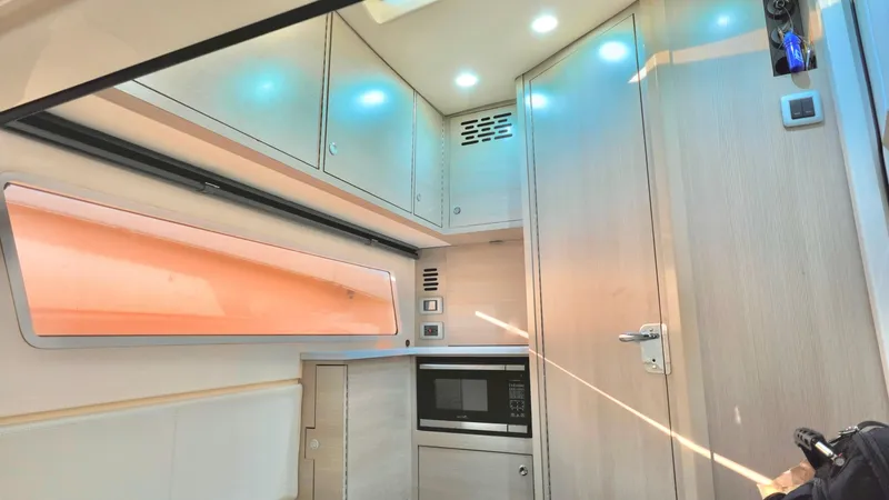  Yacht Photos Pics 2023 Scout 377 LXF interior with modern kitchen, featuring cabinets and a built-in microwave.