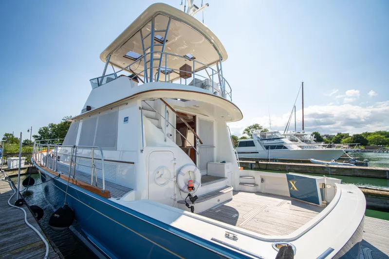 Halcyon Yacht Photos Pics 2004 Grand Banks 58 Eastbay FB yacht docked under clear skies.