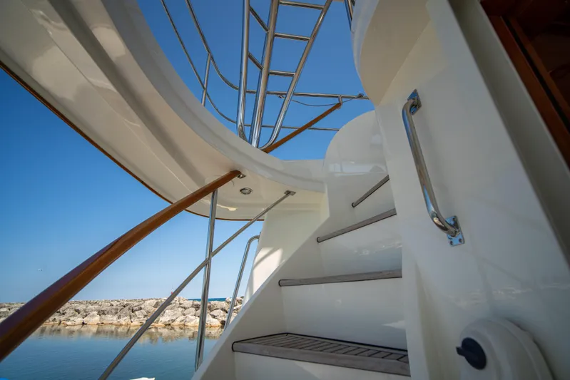 Halcyon Yacht Photos Pics Staircase on 2004 Grand Banks 58 Eastbay FB yacht, with clear blue sky background.