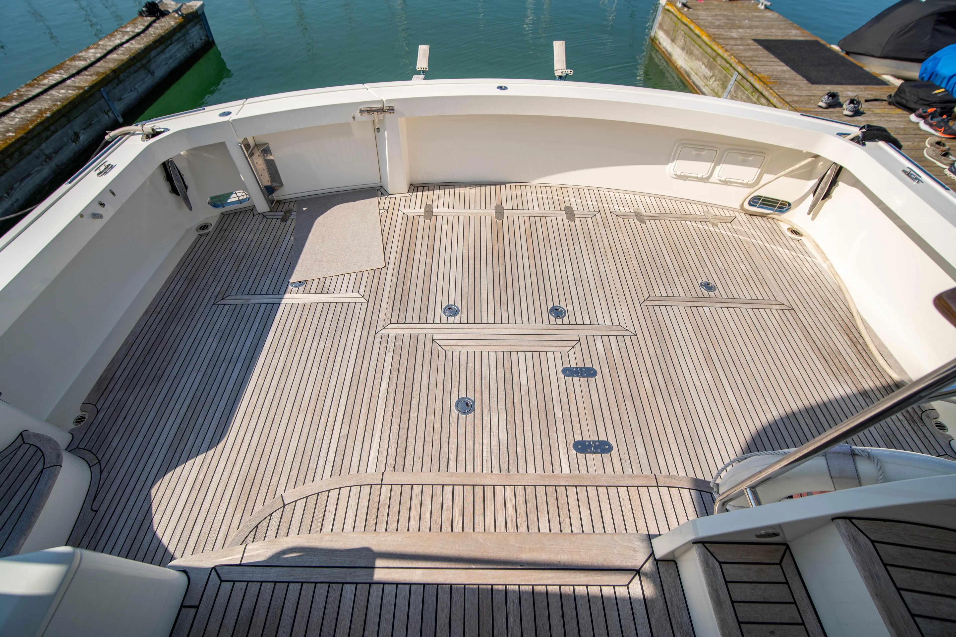 Halcyon Yacht Photos Pics Grand Banks 58 Eastbay FB 2004 yacht deck with teak flooring at marina.