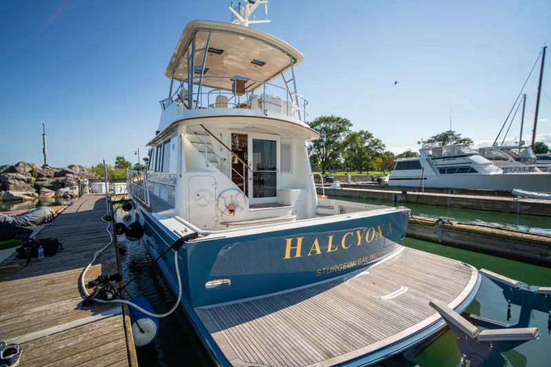 Halcyon Yacht Photos Pics 2004 Grand Banks 58 Eastbay FB yacht docked at marina, sunny day.