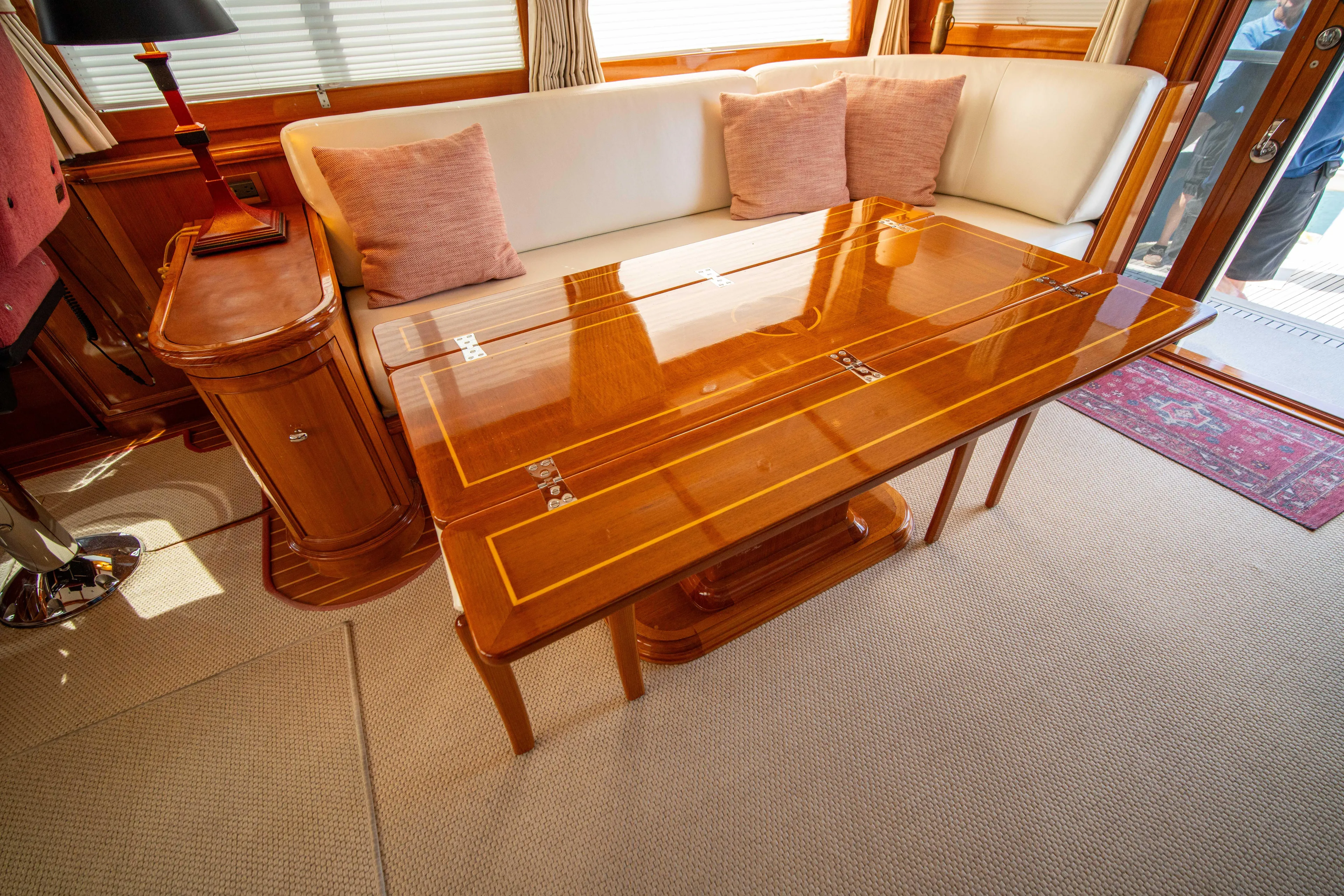 Halcyon Yacht Photos Pics Luxurious interior of 2004 Grand Banks 58 Eastbay FB yacht with elegant wood table.