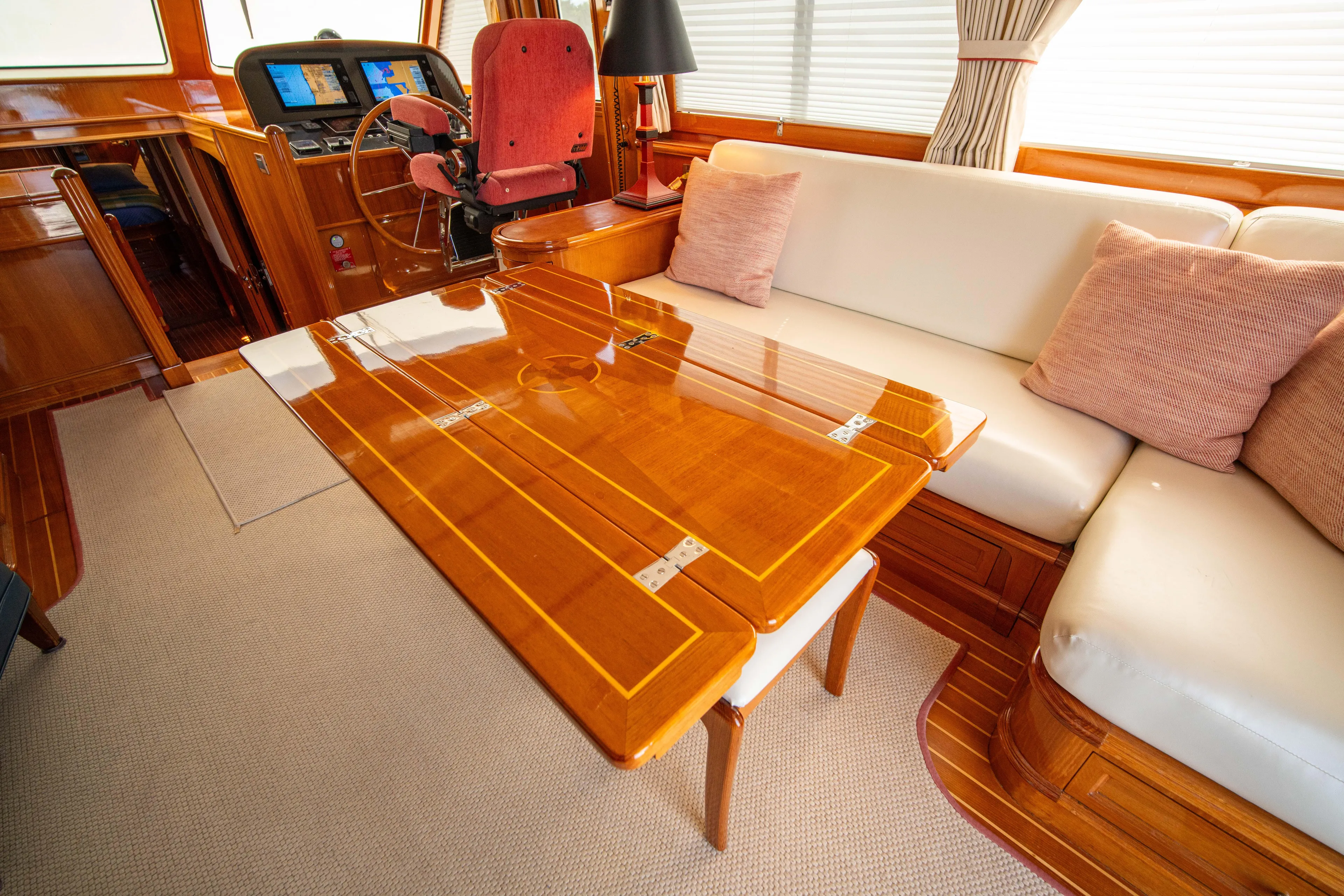 Halcyon Yacht Photos Pics Luxurious interior of 2004 Grand Banks 58 Eastbay FB yacht with polished wood table.