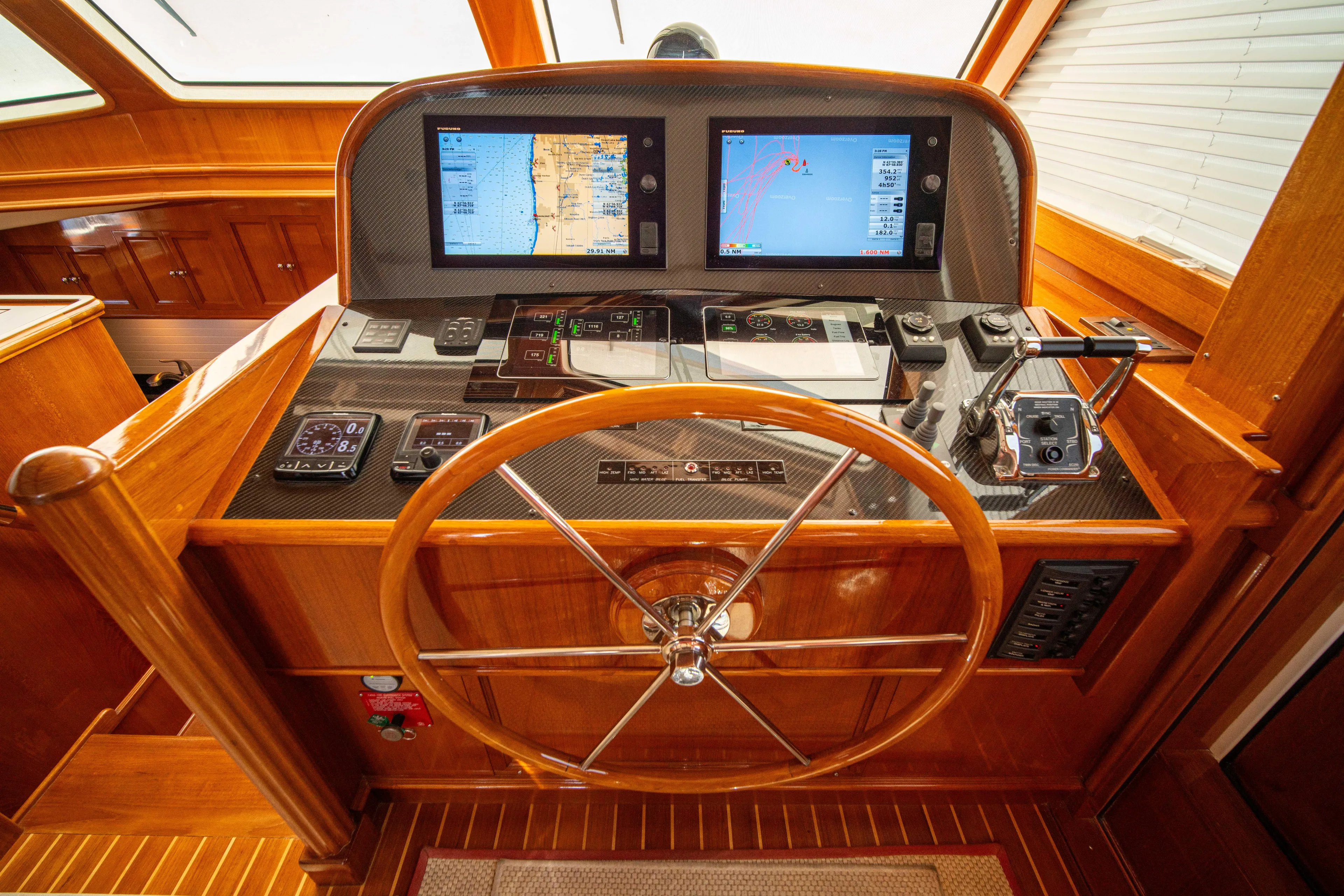Halcyon Yacht Photos Pics Helm of 2004 Grand Banks 58 Eastbay FB with dual navigation screens and wooden steering wheel.