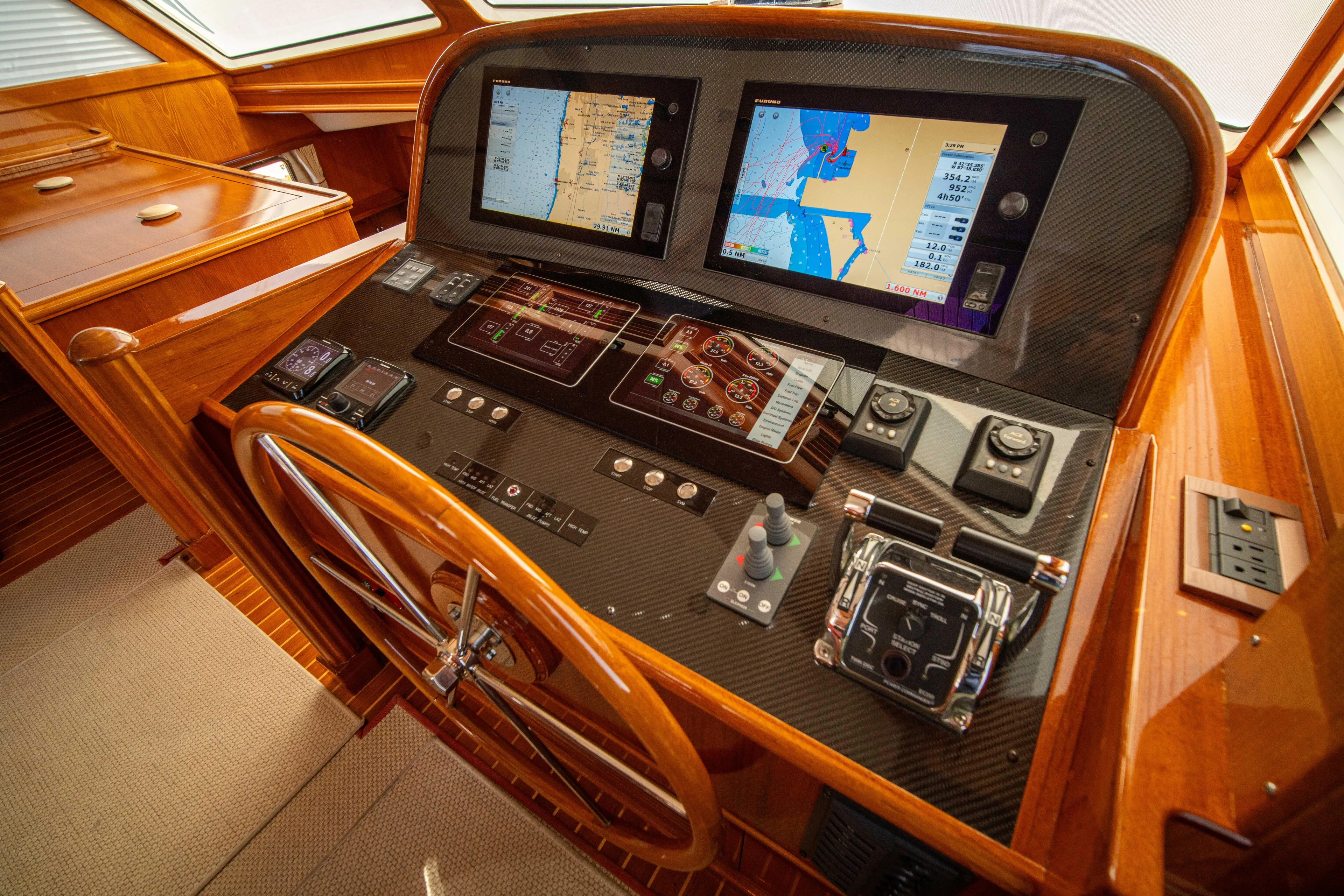 Halcyon Yacht Photos Pics Cockpit of 2004 Grand Banks 58 Eastbay FB with navigation screens and controls.