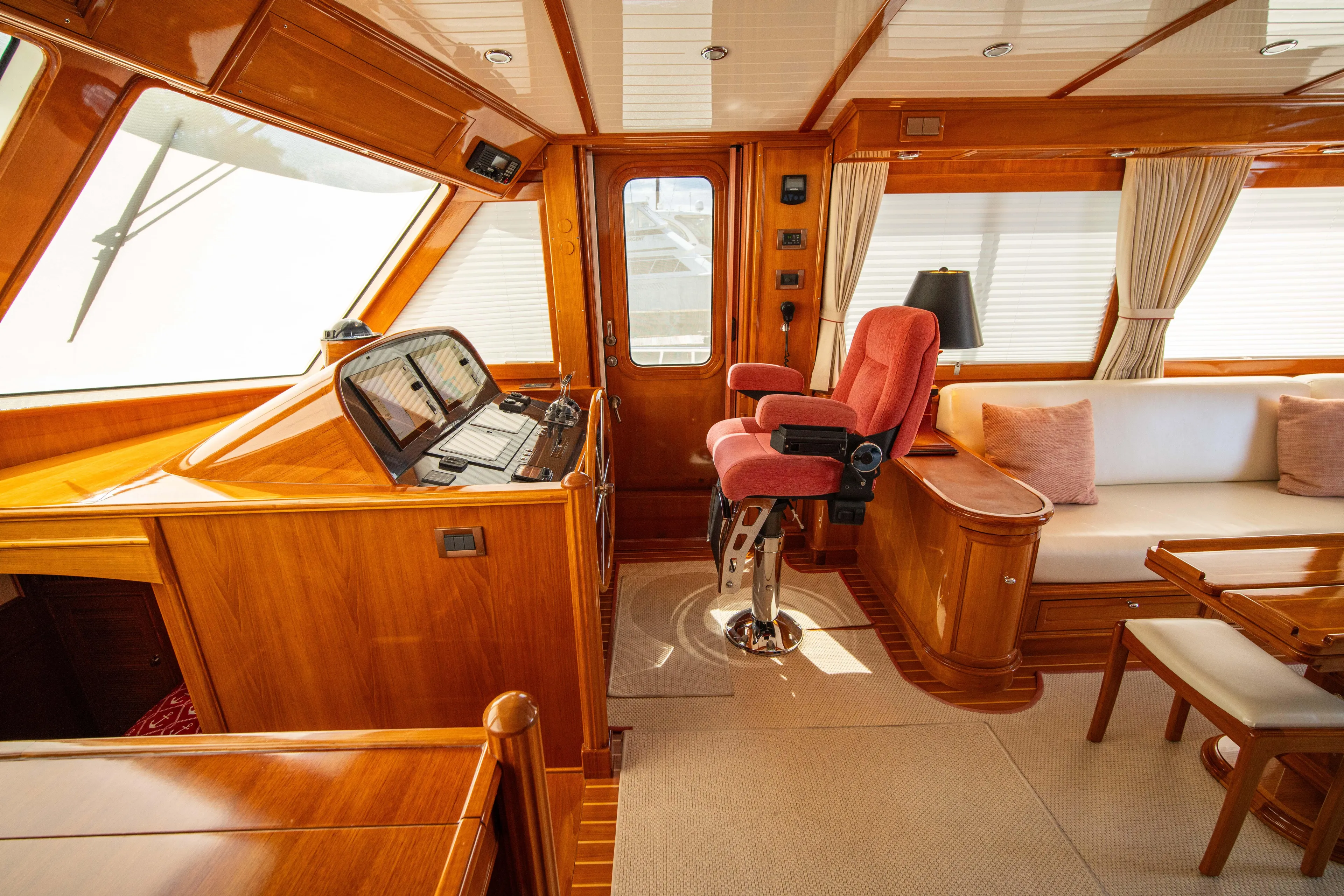 Halcyon Yacht Photos Pics Luxurious interior of 2004 Grand Banks 58 Eastbay FB yacht with wood finish and seating.
