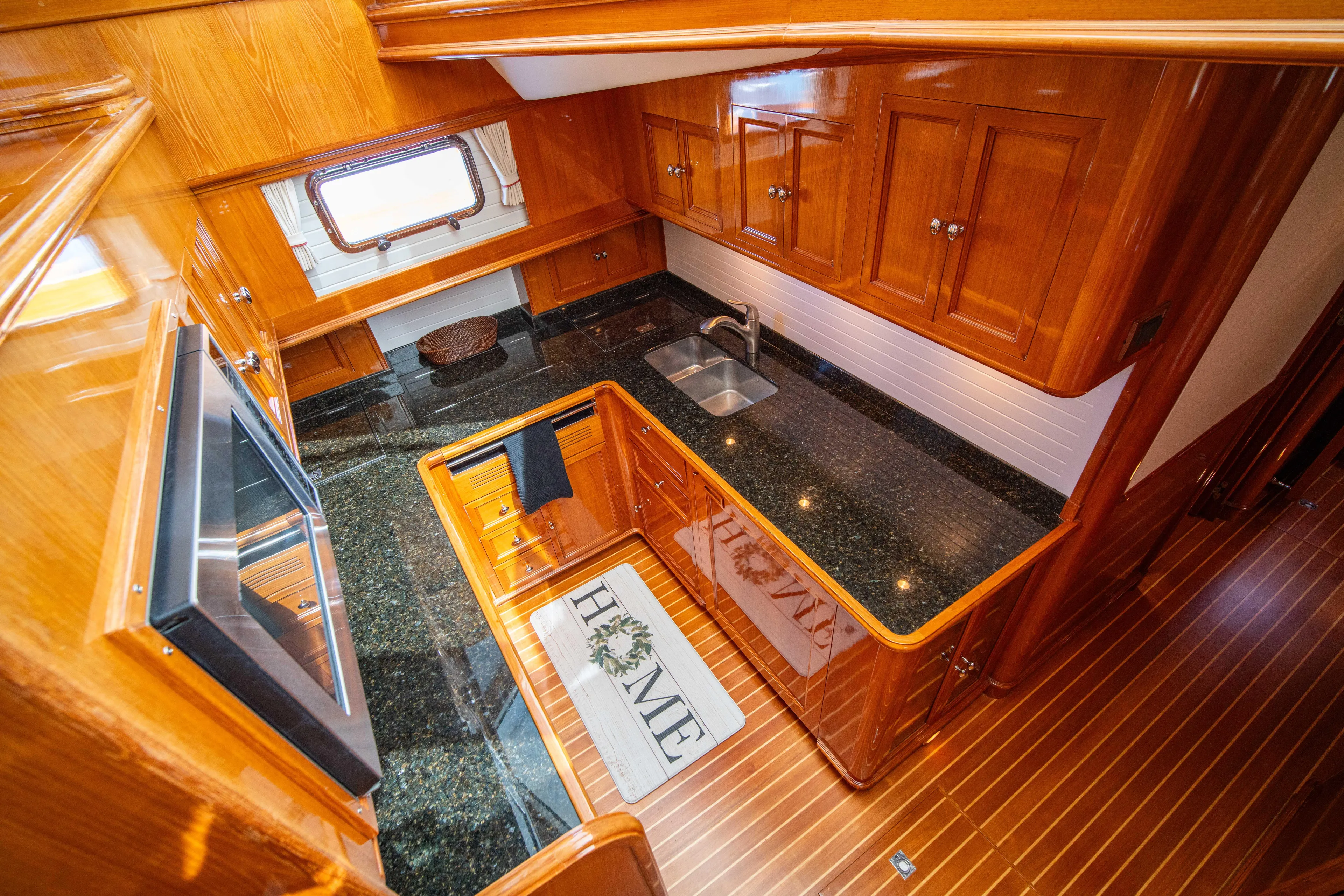 Halcyon Yacht Photos Pics Luxurious wooden kitchen interior of 2004 Grand Banks 58 Eastbay FB yacht.