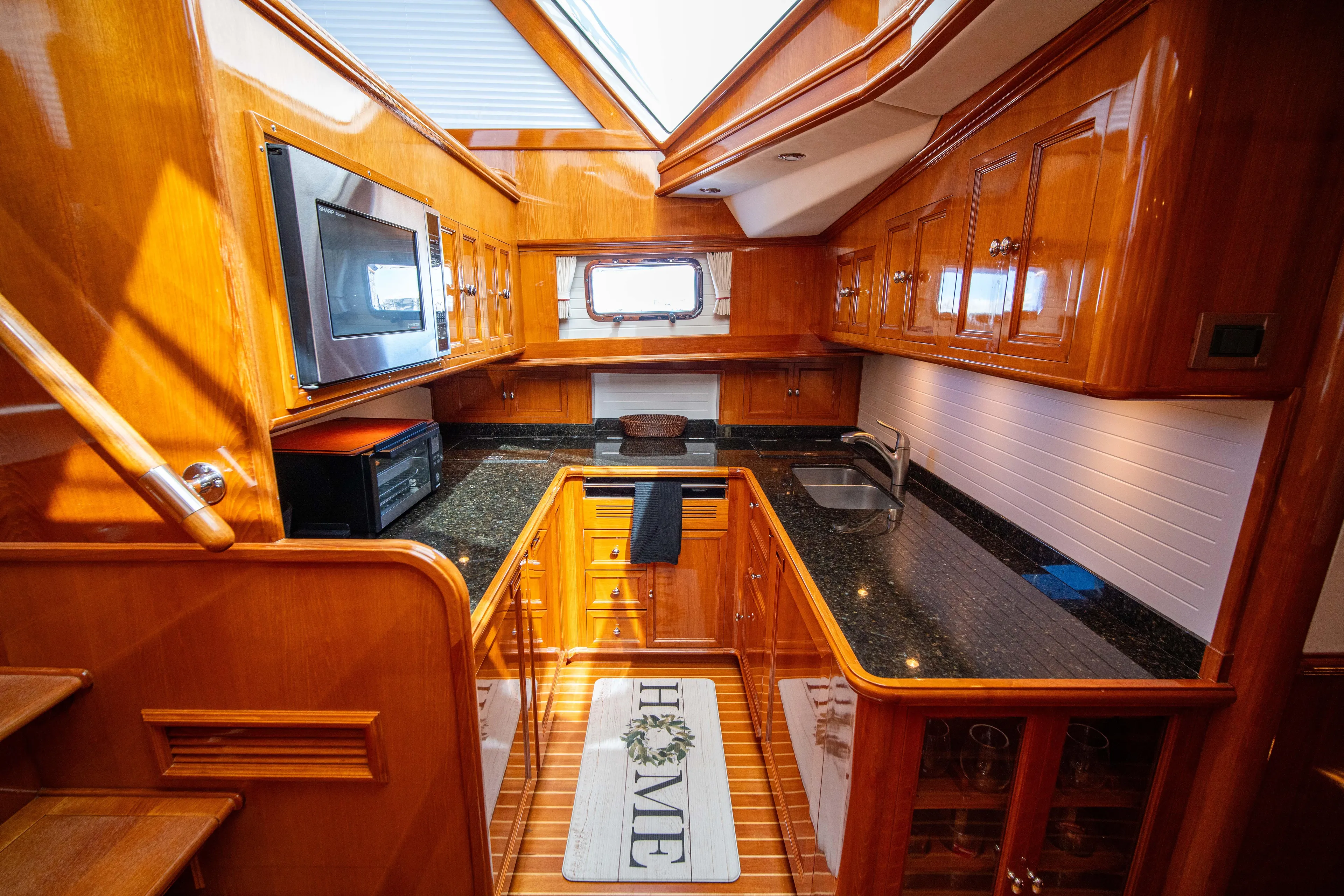 Halcyon Yacht Photos Pics Luxurious kitchen interior of 2004 Grand Banks 58 Eastbay FB yacht with wood cabinetry.