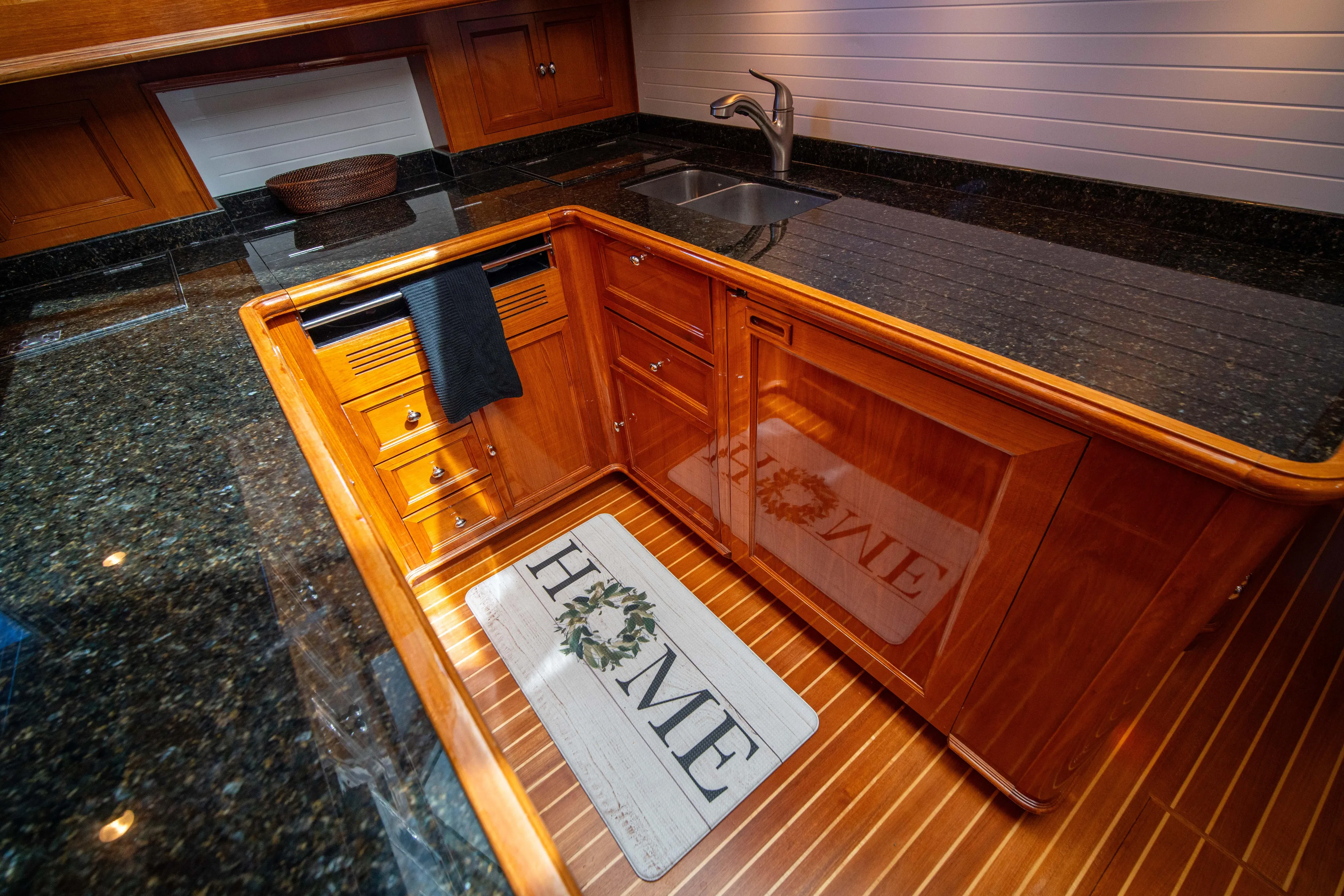 Halcyon Yacht Photos Pics Luxurious kitchen area in a 2004 Grand Banks 58 Eastbay FB yacht, featuring wood cabinetry.