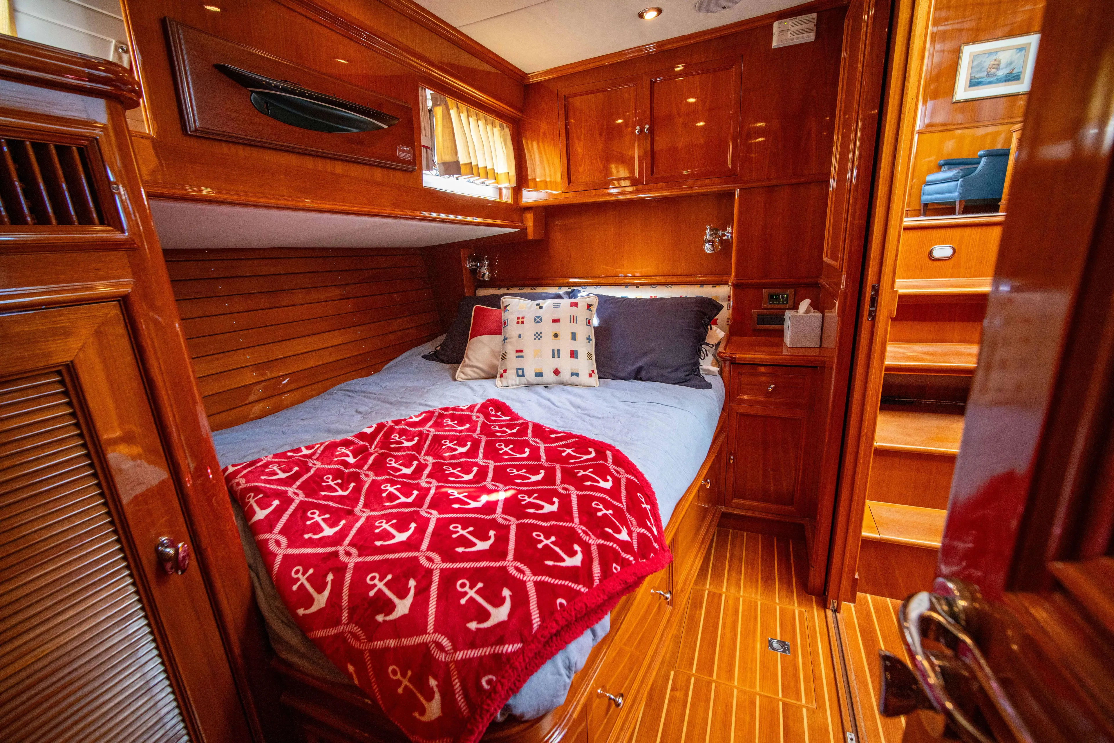 Halcyon Yacht Photos Pics Luxurious cabin interior of 2004 Grand Banks 58 Eastbay FB yacht with wooden finishes.