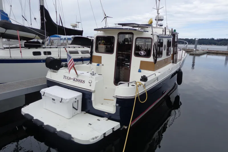 Tugs-n-kisses And Triple Axle Trailer Yacht Photos Pics 2011 Ranger Tugs R-29 Classic boat docked with trailer, rear view.