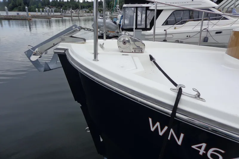 Tugs-n-kisses And Triple Axle Trailer Yacht Photos Pics 2011 Ranger Tugs R-29 Classic boat docked, featuring anchor and winch system.
