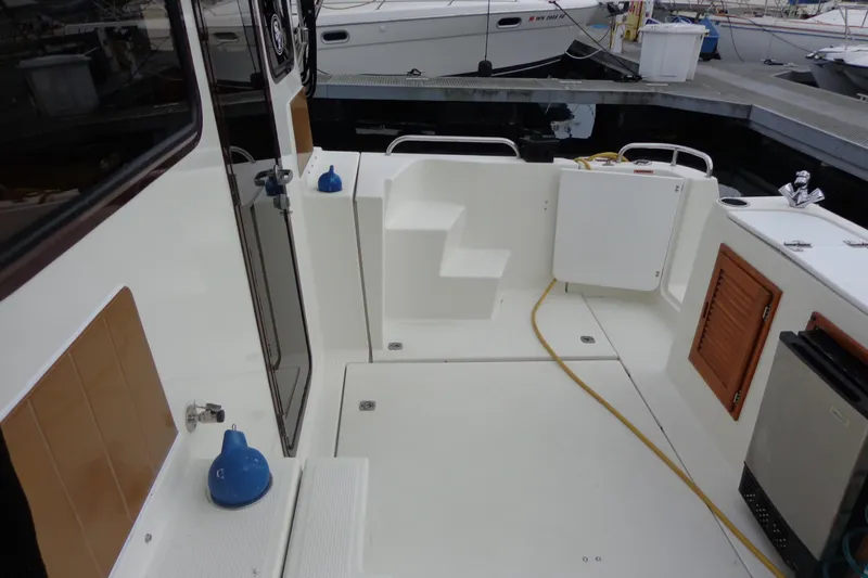 Tugs-n-kisses And Triple Axle Trailer Yacht Photos Pics 2011 Ranger Tugs R-29 Classic boat deck with trailer, featuring clean white surfaces.