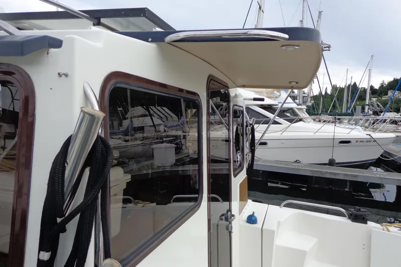 Tugs-n-kisses And Triple Axle Trailer Yacht Photos Pics 2011 Ranger Tugs R-29 Classic docked, showcasing exterior details and marina setting.