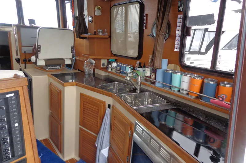 Tugs-n-kisses And Triple Axle Trailer Yacht Photos Pics 2011 Ranger Tugs R-29 Classic interior with kitchen sink, cabinets, and countertop accessories.