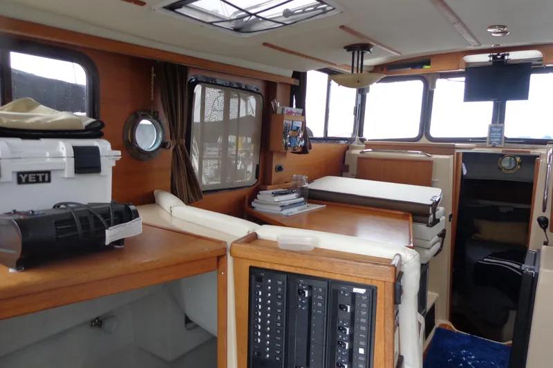 Tugs-n-kisses And Triple Axle Trailer Yacht Photos Pics Interior of 2011 Ranger Tugs R-29 Classic boat, featuring cozy seating and modern amenities.