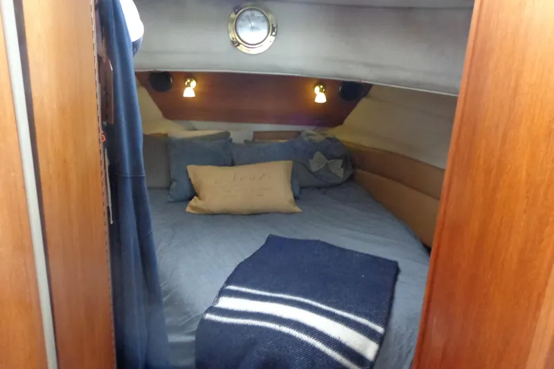Tugs-n-kisses And Triple Axle Trailer Yacht Photos Pics Cozy cabin interior of 2011 Ranger Tugs R-29 Classic, featuring a comfortable bed and nautical decor.
