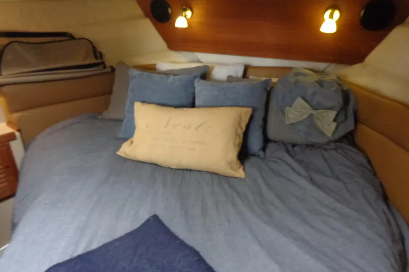 Tugs-n-kisses And Triple Axle Trailer Yacht Photos Pics Cozy cabin interior of 2011 Ranger Tugs R-29 Classic, featuring a comfortable bed with pillows.