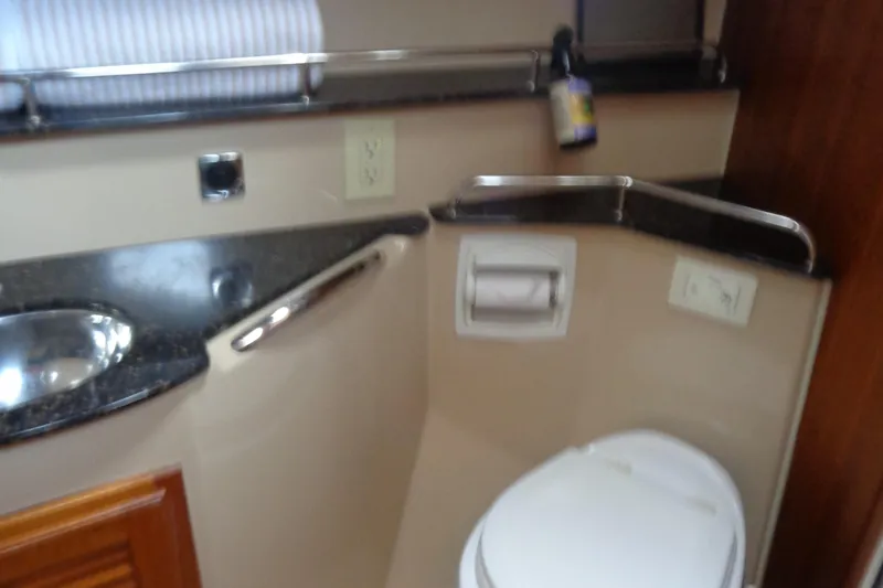 Tugs-n-kisses And Triple Axle Trailer Yacht Photos Pics 2011 Ranger Tugs R-29 Classic bathroom with sink, toilet, and countertop.