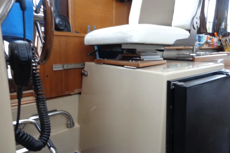 Tugs-n-kisses And Triple Axle Trailer Yacht Photos Pics 2011 Ranger Tugs R-29 Classic interior helm with seat and radio equipment.