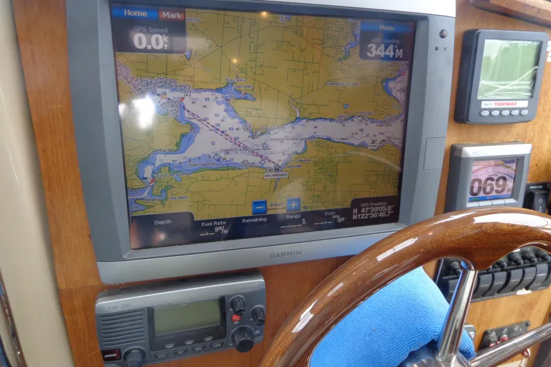 Tugs-n-kisses And Triple Axle Trailer Yacht Photos Pics Boat navigation system on 2011 Ranger Tugs R-29 Classic, featuring Garmin GPS and controls.