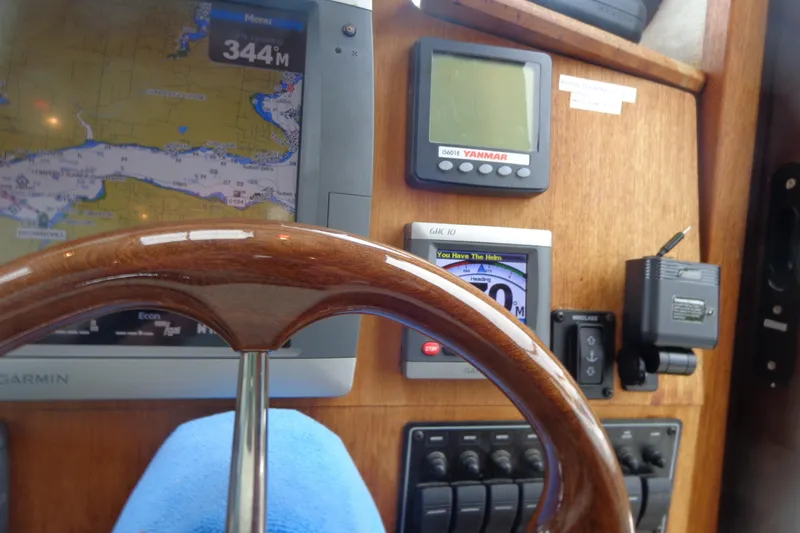 Tugs-n-kisses And Triple Axle Trailer Yacht Photos Pics Steering wheel and navigation instruments on 2011 Ranger Tugs R-29 Classic boat.
