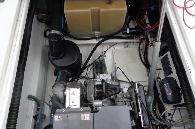 Tugs-n-kisses And Triple Axle Trailer Yacht Photos Pics Engine compartment of 2011 Ranger Tugs R-29 Classic with trailer, showcasing mechanical components.