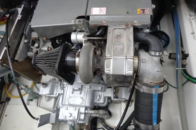 Tugs-n-kisses And Triple Axle Trailer Yacht Photos Pics Engine compartment of a 2011 Ranger Tugs R-29 Classic with trailer, showcasing mechanical components.