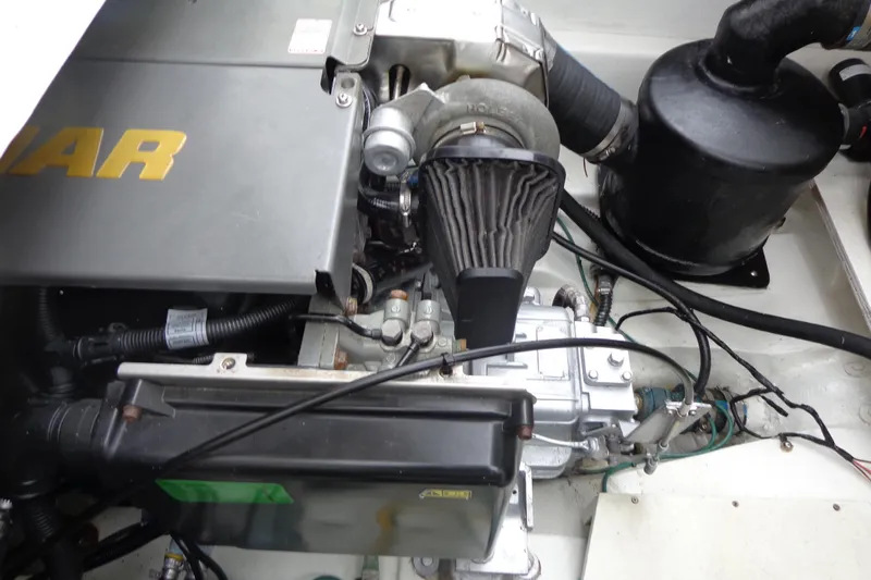 Tugs-n-kisses And Triple Axle Trailer Yacht Photos Pics Engine compartment of a 2011 Ranger Tugs R-29 Classic with trailer, showcasing mechanical components.