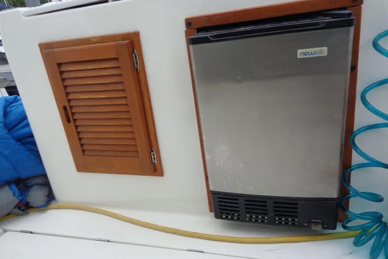 Tugs-n-kisses And Triple Axle Trailer Yacht Photos Pics 2011 Ranger Tugs R-29 Classic interior with fridge and wooden cabinet.