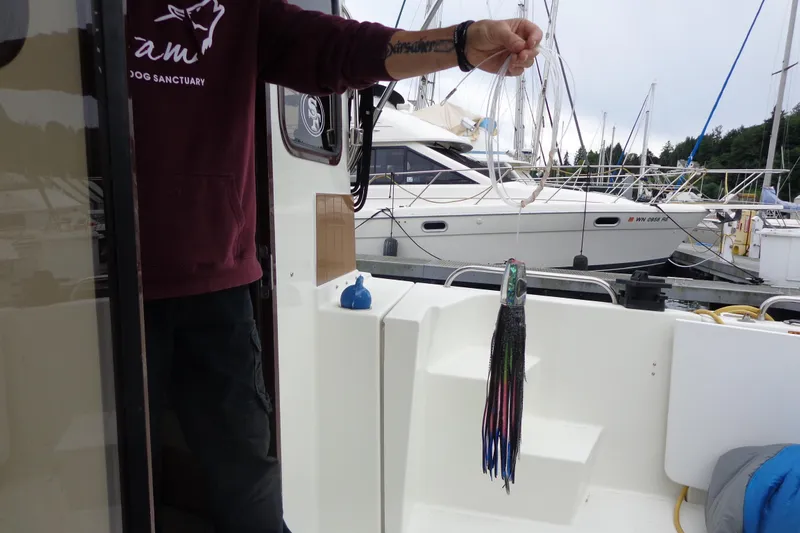 Tugs-n-kisses And Triple Axle Trailer Yacht Photos Pics 2011 Ranger Tugs R-29 Classic boat with fishing lure, docked at marina.