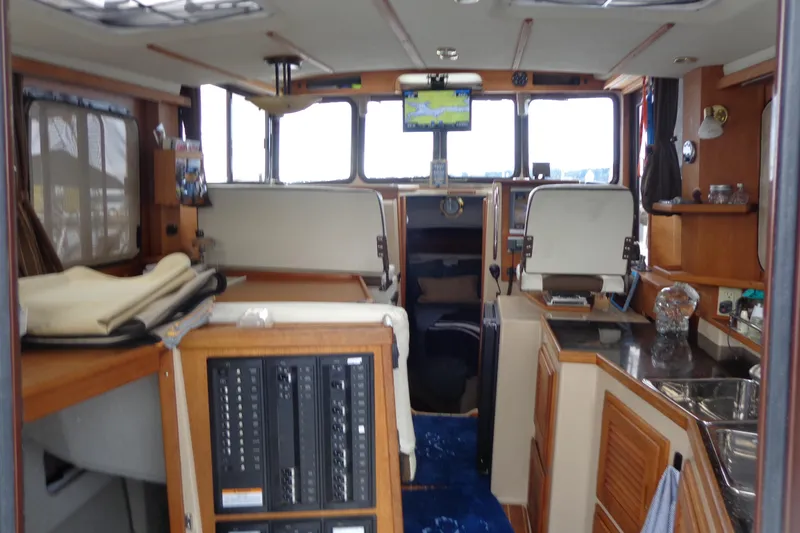 Tugs-n-kisses And Triple Axle Trailer Yacht Photos Pics Interior of 2011 Ranger Tugs R-29 Classic boat, featuring navigation equipment and cozy seating.