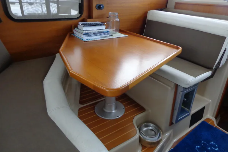 Tugs-n-kisses And Triple Axle Trailer Yacht Photos Pics 2011 Ranger Tugs R-29 Classic interior with wooden table and seating area.