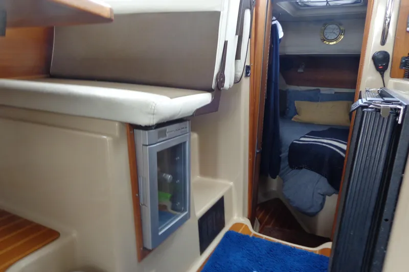 Tugs-n-kisses And Triple Axle Trailer Yacht Photos Pics 2011 Ranger Tugs R-29 Classic interior with cozy cabin and compact fridge.