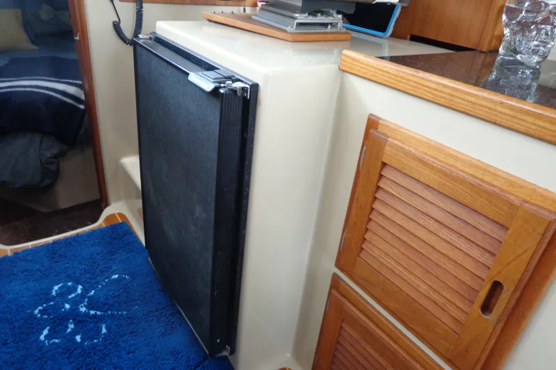 Tugs-n-kisses And Triple Axle Trailer Yacht Photos Pics Interior of 2011 Ranger Tugs R-29 Classic, featuring compact kitchen area with wooden cabinetry.