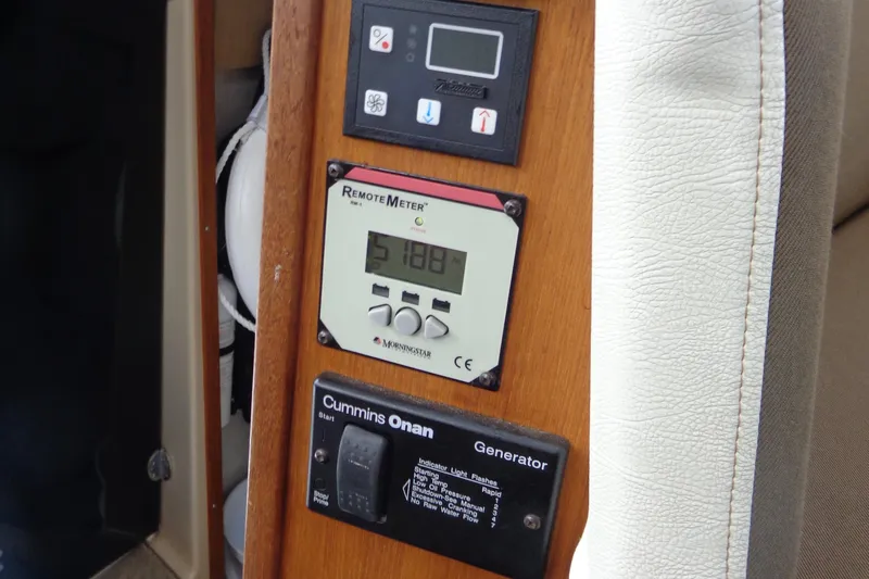 Tugs-n-kisses And Triple Axle Trailer Yacht Photos Pics Control panel of 2011 Ranger Tugs R-29 Classic, featuring generator and remote meter.