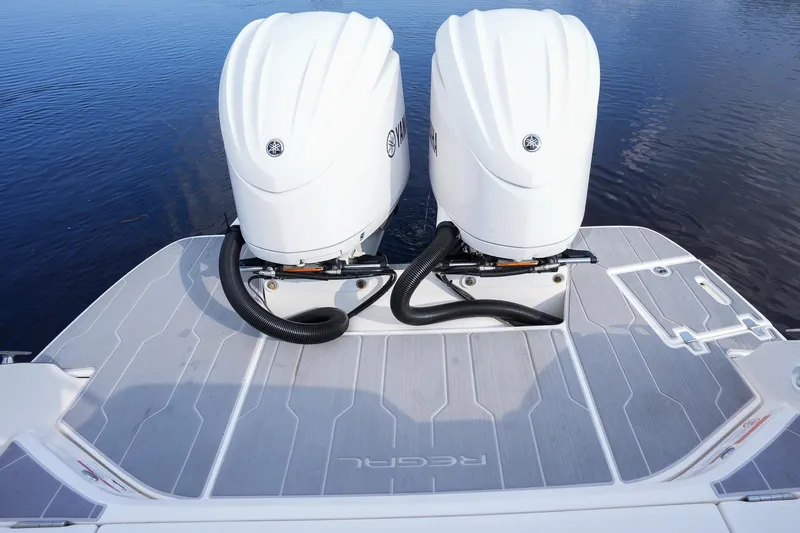  Yacht Photos Pics 2023 Regal 29 OBX boat with dual outboard engines on a calm water surface.