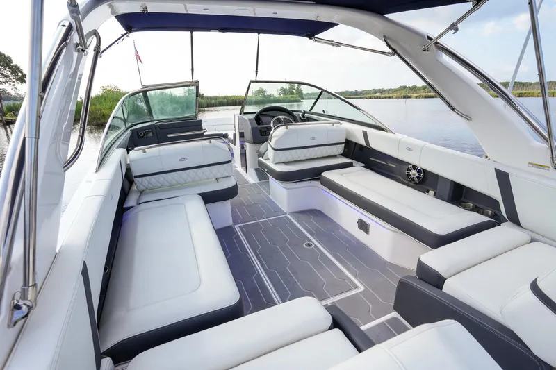  Yacht Photos Pics 2023 Regal 29 OBX boat interior with luxurious seating and modern design on a serene waterway.