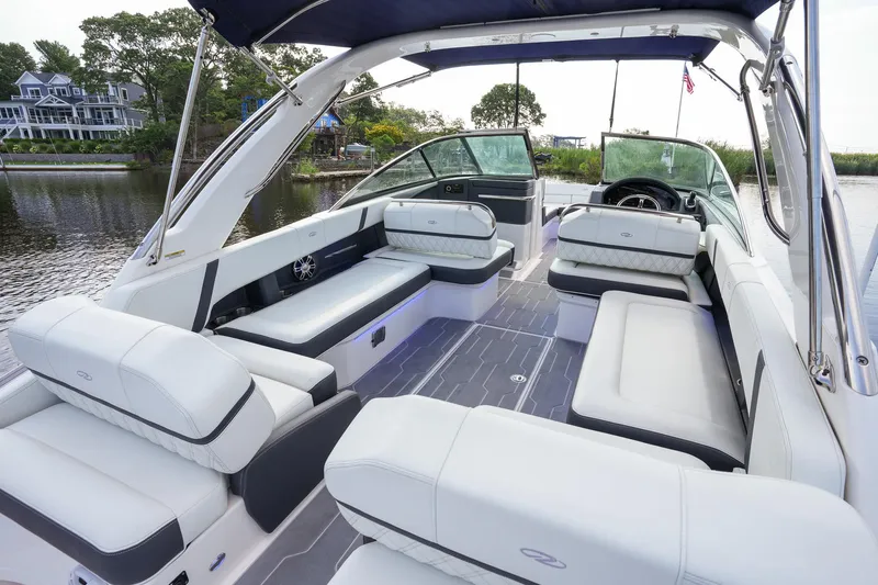  Yacht Photos Pics 2023 Regal 29 OBX boat interior with luxurious seating and modern design on a serene waterway.