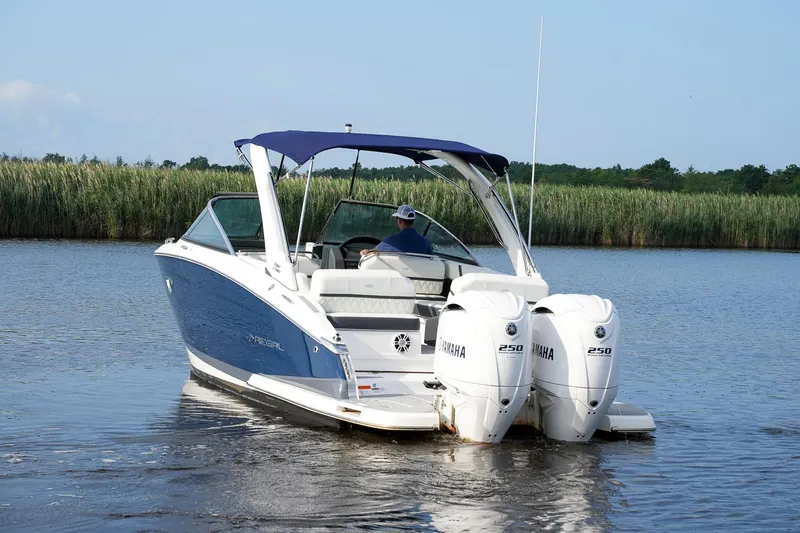  Yacht Photos Pics 2023 Regal 29 OBX boat with dual Yamaha engines on a calm waterway.
